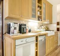 A kitchen with wooden cabinets and appliances in a 3-room apartment.