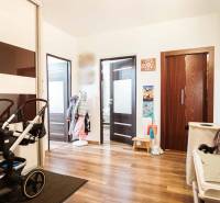 Entrance hall with wood-patterned flooring in a 3-room apartment.