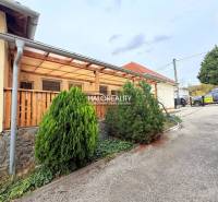 In front of the hotel or guesthouse in Podhájska with a landscaped garden and terrace.