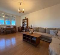 Living room in a 2-room apartment with a wooden decor floor and comfortable seating.