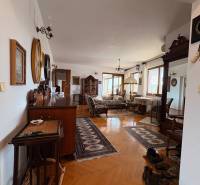 A 5 or more bedroom apartment with wood-patterned flooring, classic furniture, and carpets.