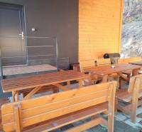 Cottage on Stráne in Martin with wooden benches and a grill on the terrace.