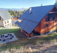 A cottage in Martin on Stráne surrounded by nature with a view of the mountains and a fireplace.