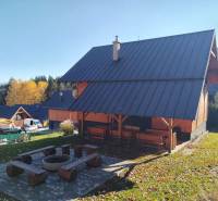 A cottage on Stráne Street in Martin with a seating area and a fire pit surrounded by nature.