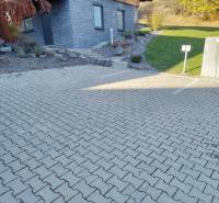 Parking lot at the cottage in the Martin district of Stráne with paved tiles and a landscaped garden.