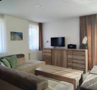 A bright room in a cabin with a comfortable sofa and a wooden decor floor.