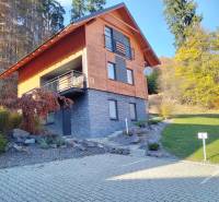 A cottage in Martin on Stráne with stone cladding, wooden decor, and a parking space.