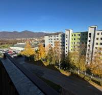 View from the apartment on Aurela Stodolu in Martin, with hills and a block of flats in the background.