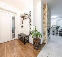 Interior of a family house with a wood-patterned floor, stone fireplace, and comfortable living room.