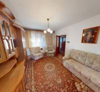 Living room in a family house with a classic wall unit and carpet.