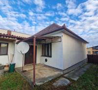 A family house in Bojná with a simple exterior and a satellite dish in the yard.
