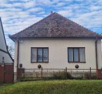 A family house in Bojná with a gable roof, in front of which is a green lawn.