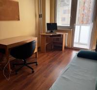 A workspace in a 3-room apartment with a wooden decor floor, bright room.