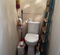 Toilet with a shelf and equipment in a 3-room apartment.