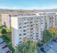 Apartment building on Svätoplukova Street in Pezinok, with a parking lot and nature in the background.