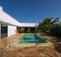 White architecture with a pool amidst greenery in Paje, Unguja South Region.