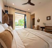 Bedroom interior with a spacious bed and a view of the terrace, House construction.
