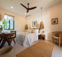 A bright bedroom with pendant lamps and wicker furniture in a family house.