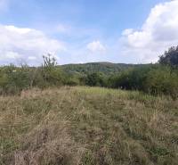 The landscape on the recreational grounds in Jabloňovce, part of Horné Jabloňovce, with a view of the wooded hills.