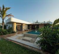 A family house in Paje, Unguja South Region with a pool, surrounded by lush vegetation and paving.