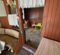 Interior of a cottage in Záhrady with wooden paneling and carpet.