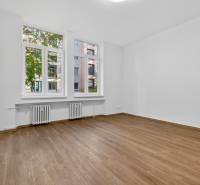 A bright room in a 4-room apartment with a wooden decor floor and large windows.