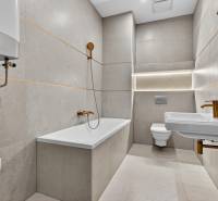 Bathroom in a 4-room apartment with a bathtub, sink, and toilet in neutral shades.