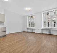 A kitchen in a 4-room apartment with a wooden decor floor and light walls.