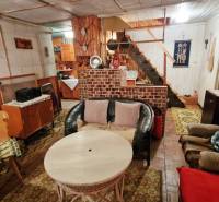 A cottage with rustic furniture and comfortable seating, floor with wooden decor.