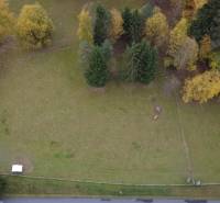 Aerial view of green recreational plots surrounded by trees on Čertov street, Lazy pod Makytou.
