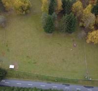 Recreational plots in Lazy pod Makytou, Čertov surrounded by trees and an access asphalt road.