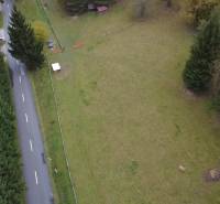 Aerial view of recreational plots in Lazy pod Makytou, Čertov, near a road surrounded by trees.