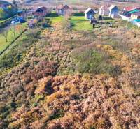 Aerial view of residential plots in Radnovce with rural houses and greenery.