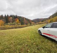 A car in a meadow surrounded by autumn forests at the Recreational Grounds in Lazy pod Makytou, Čertov.
