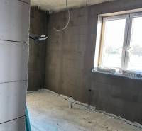 Room under construction on Vyšná Šebastová street with a view of a family house, window openings.