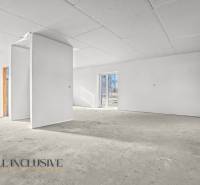 An empty interior in a family house with white walls and large windows.