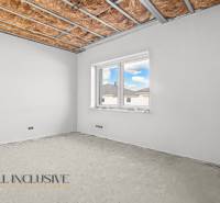 Raw room in a family house with a window and an insulated ceiling.
