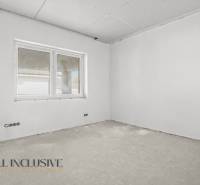 A construction room in a family house with a window and an unfinished floor, ready for completion.