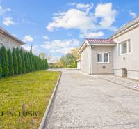 A family house in Veľké Kosihy with a driveway and a well-maintained lawn.