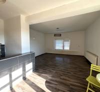 Interior of a family house with a spacious room, wooden decor flooring, and a dining area.