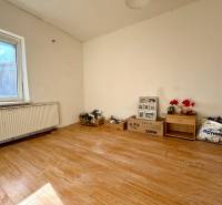 A room in a family house with a wooden decor floor and furniture.