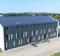 The building on Levická Street in Vráble with offices, modern architecture, and green surroundings.
