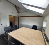 Office with a dining table and wooden decor flooring, seating for four people.