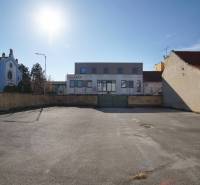 A plot in Nové Zámky suitable for living, surrounded by buildings, clean asphalt surfaces.