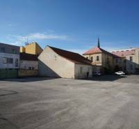 In the courtyard in Nové Zámky, there are various buildings suitable for plots - housing.