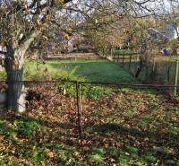 A plot for residential purposes in Dolná Krupá on M.H. Chvoteková Street with autumn leaves and trees.