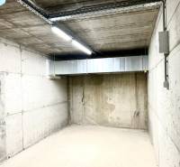 Concrete garage interior with lighting and ventilation.