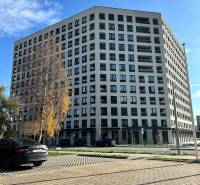 Apartment building on Karpatská Street in Poprad, surrounding parking lot and trees.