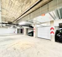 Garages with parking spaces, concrete ceiling, and lighting on Karpatská Street in Poprad.
