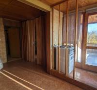 The interior of a family house with doors to the terrace and walls with a wooden decor.